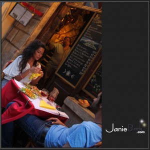 Waiter looking over beautiful lovers at an outdoor cafe